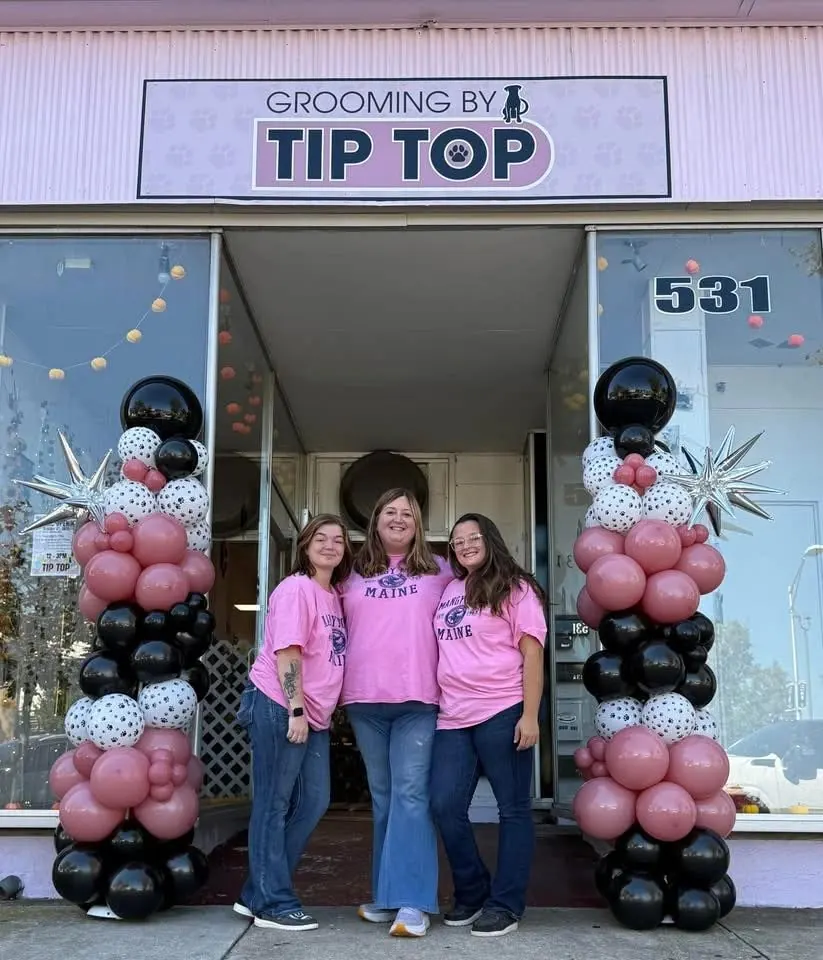 Shelly, Madison and Shilo in pink Grooming by Tip Top shirts outside the salon at 531 East Landis Avenue